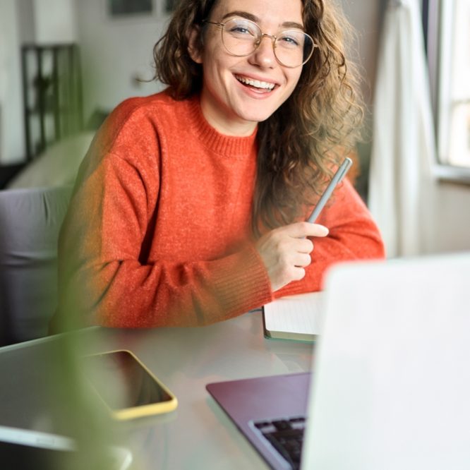 Vertical,Portrait,Of,Happy,Young,Woman,Student,Laughing,Using,Laptop